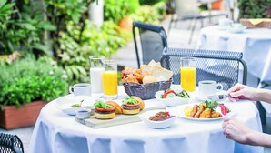 A table set outdoors with breakfast items including sandwiches, pastries, and a salad. - Hotel JAL City Kannai Yokohama (Yokohama)