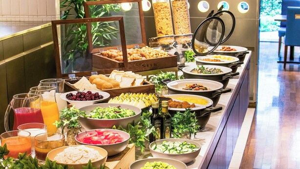 A buffet with various food items and drinks, including fruits, salads, and bread. - Hotel JAL City Kannai Yokohama (Yokohama)