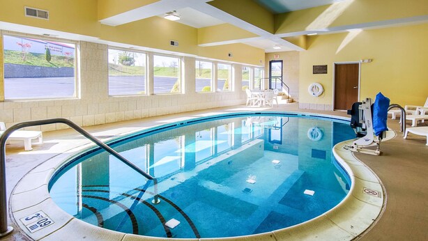 An indoor swimming pool with clear water, surrounded by windows and a yellow wall. - Comfort Suites Wytheville near Conference Center (Wytheville)