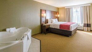 A hotel room with a large bed, a separate bathroom with a bathtub, and a window with curtains. - Comfort Suites Wytheville near Conference Center (Wytheville)