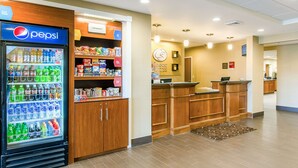 A hotel lobby with a Pepsi refrigerator stocked with beverages, a reception desk, and a clock on the wall. - Comfort Suites Wytheville near Conference Center (Wytheville)