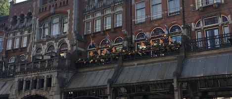 A historic building with ornate architecture, including arched windows and decorative balconies.