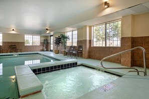 A swimming pool with a hot tub, seating area, and large windows. - Best Western Laramie Inn & Suites (Laramie)