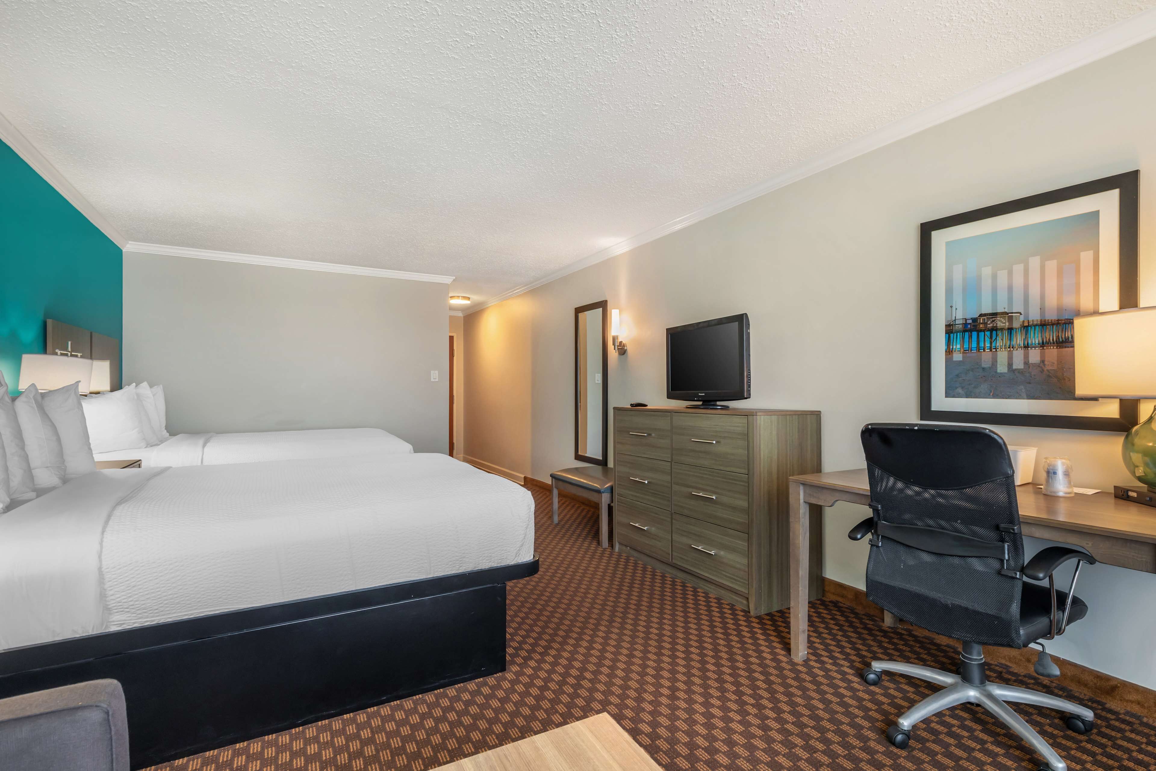 standard room, 2 queen beds, non smoking, refrigerator & microwave (third bed is a sofabed) | in-room safe, desk, blackout curtains, iron/ironing board