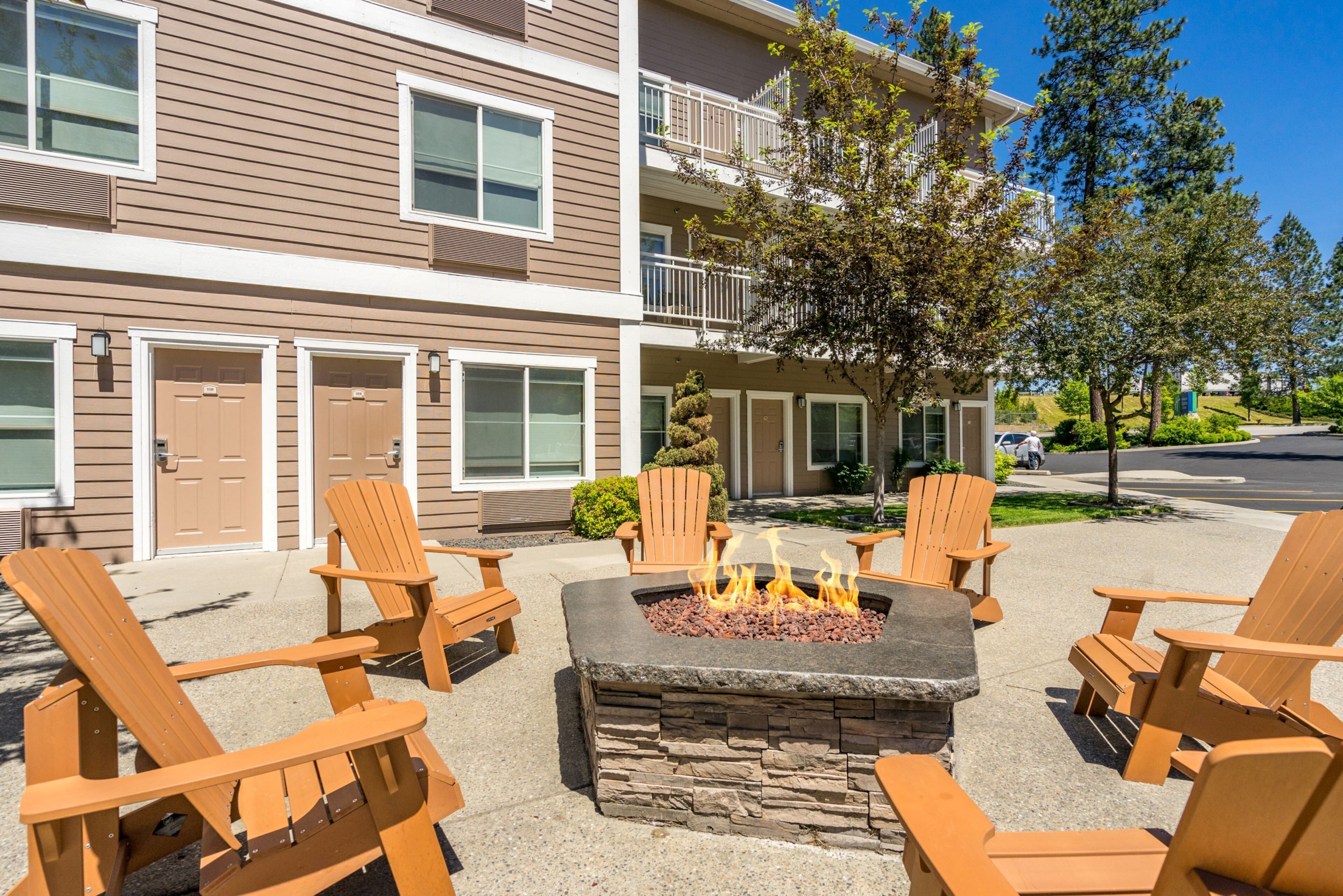 A building with a fire pit and outdoor seating.