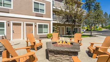 A building with a fire pit and outdoor seating.