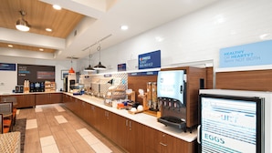 A modern cafe with a coffee bar, breakfast options, and a digital menu display. - Holiday Inn Express & Suites Interstate 90 by IHG (Coeur d'Alene)