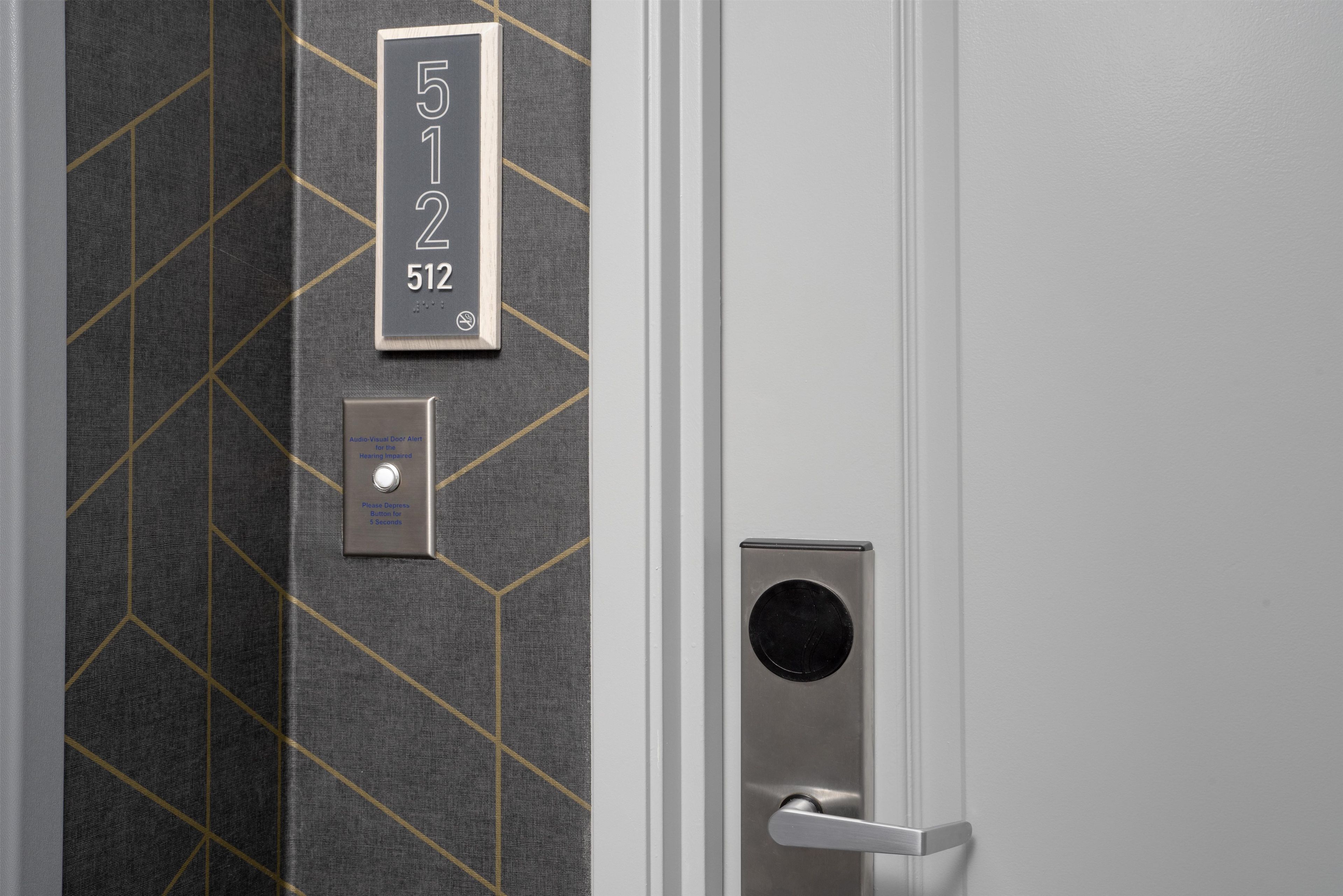 A door with a numeric keypad and a doorbell.