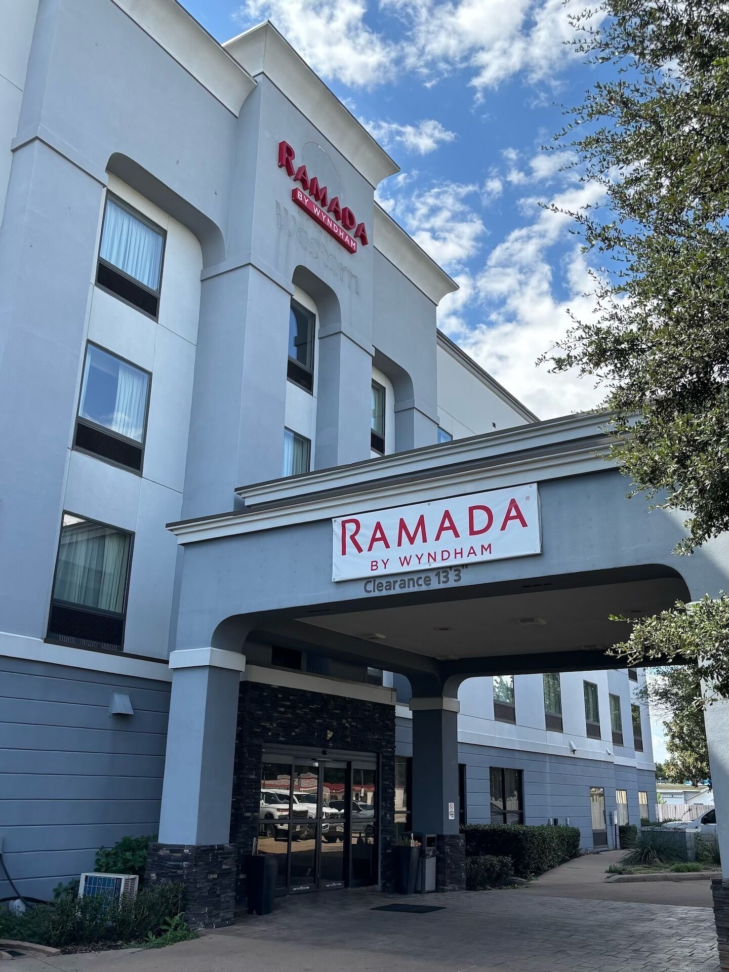 Un edifici amb un rètol que diu "RAMADA BY WYNDHAM" i "Clearance 13".