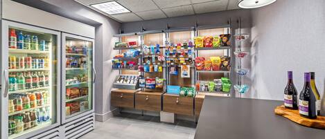 A self-service beverage station with refrigerated drinks and snacks.