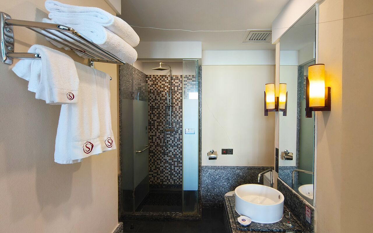 deluxe city view double bed room | bathroom | rainfall showerhead, free toiletries, hair dryer, bathrobes