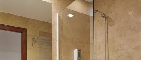 A bathroom with a sink, mirror, shower, and bathtub.