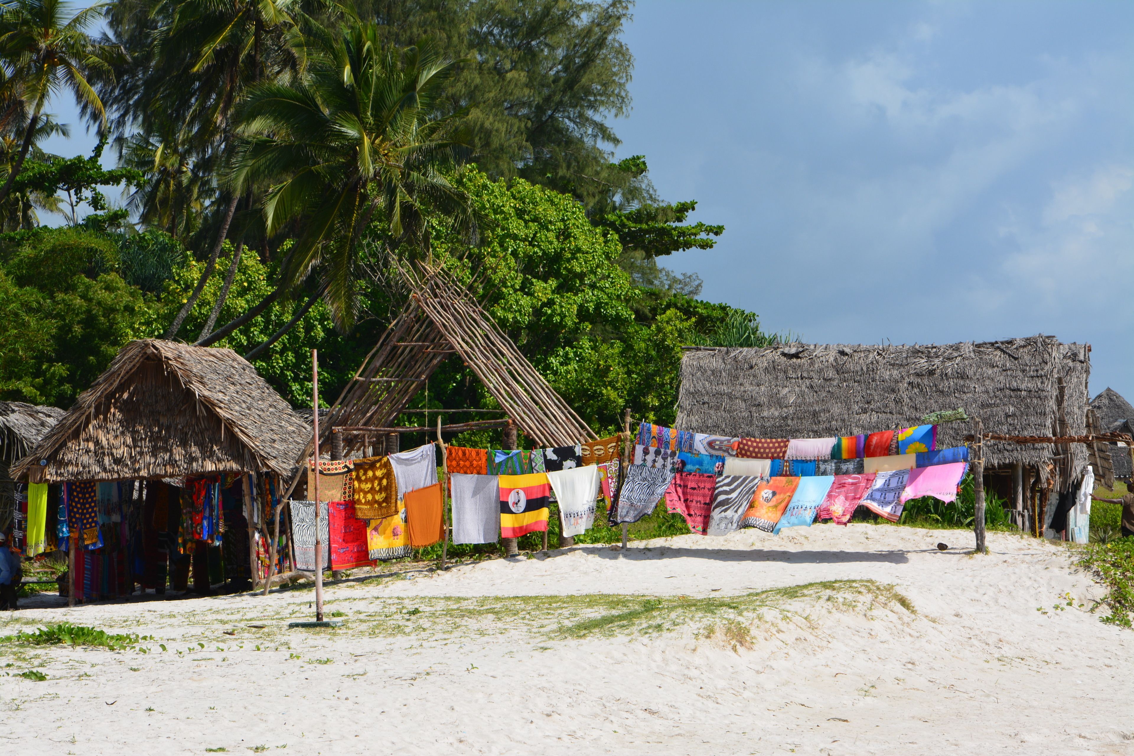 on the beach, white sand, beach umbrellas, beach towels