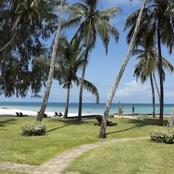 On the beach, white sand, beach umbrellas, beach towels