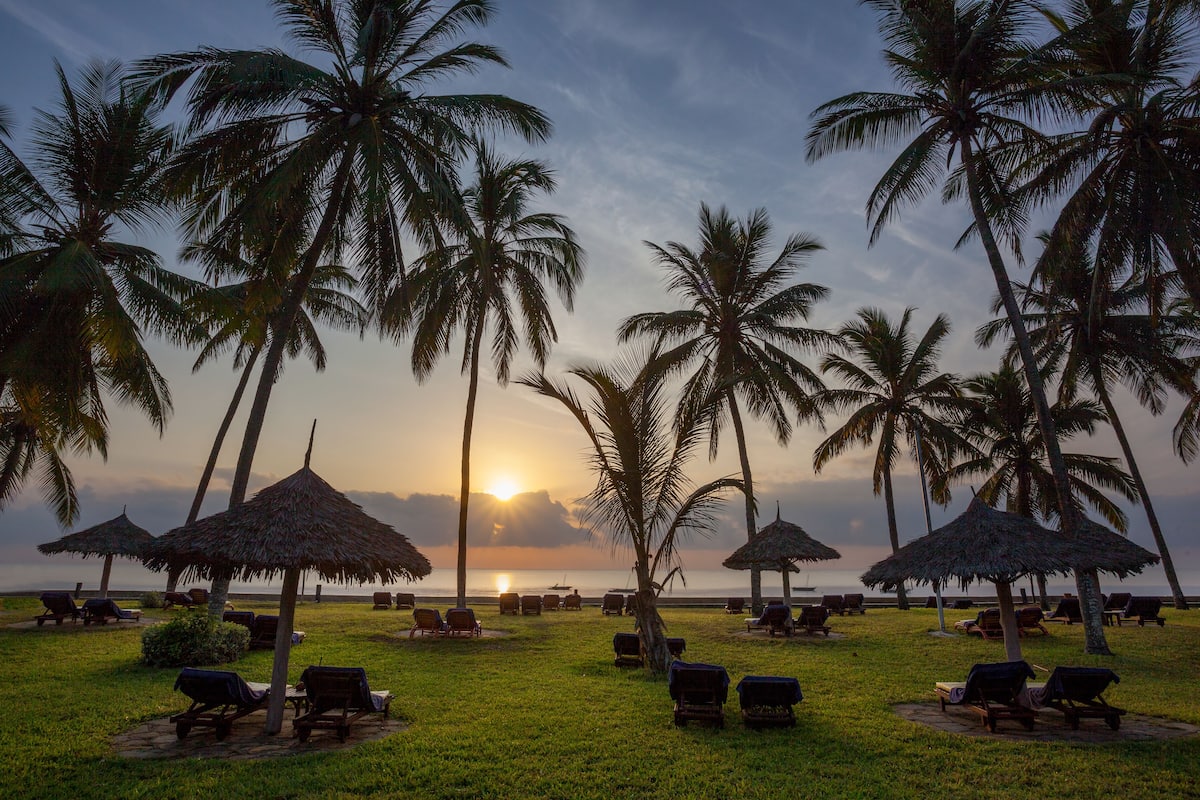 on the beach, white sand, beach umbrellas, beach towels