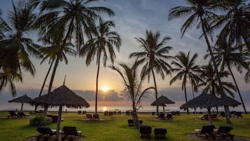 On the beach, white sand, beach umbrellas, beach towels