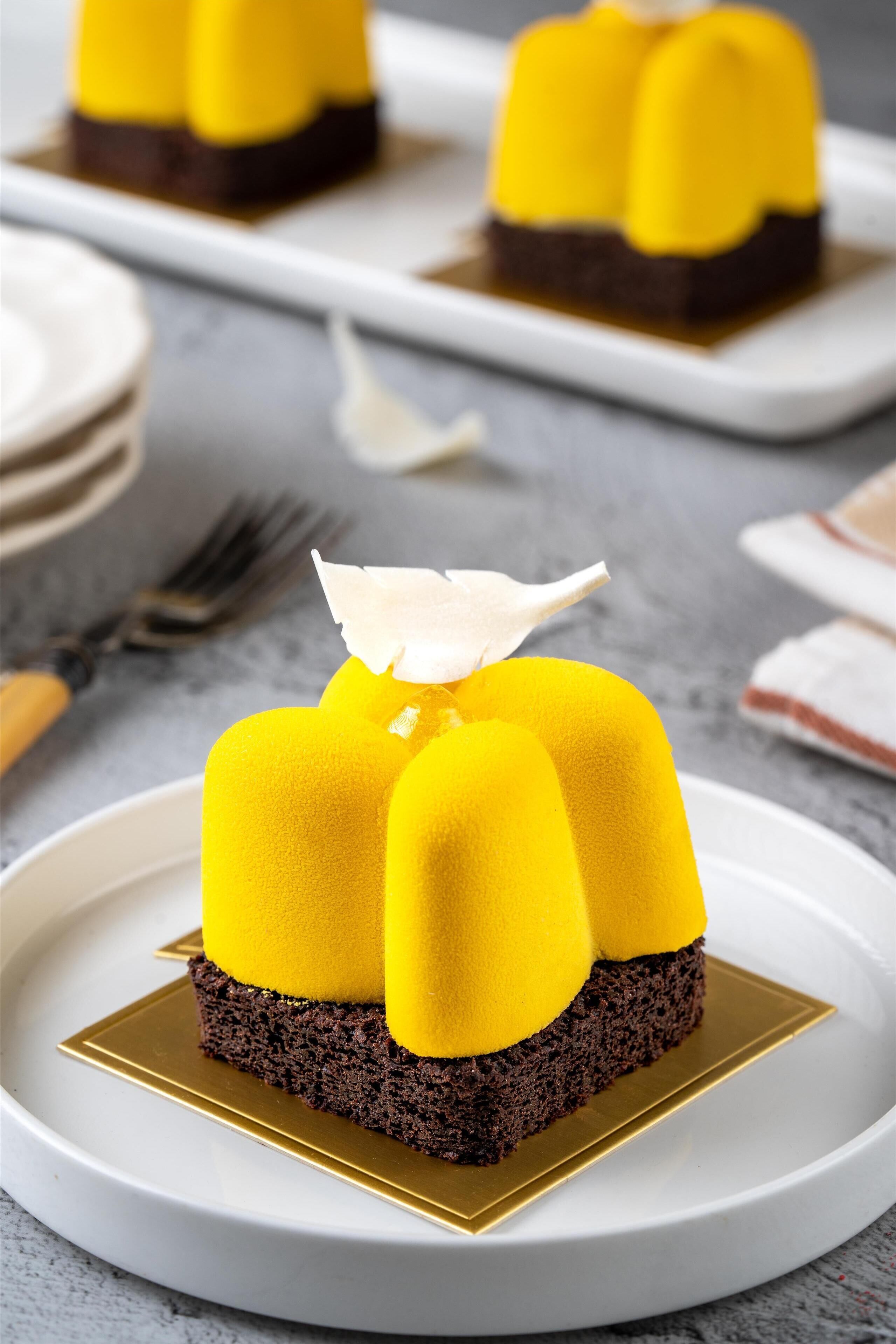 A dessert on a white plate with a gold base.