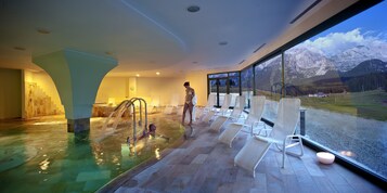 Una piscina cubierta, tumbonas