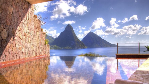 An infinity pool with a view of mountains and a body of water. - Jade Mountain Resort (Soufrière)