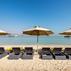 On the beach, white sand, sun loungers, beach bar
