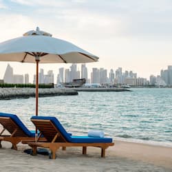 On the beach, white sand, sun loungers, beach bar