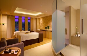 A modern hotel room with a large bed, a sitting area, a bathroom with a glass shower, and a view of the outdoors. - Hyatt Regency Dongguan (Dongguan)