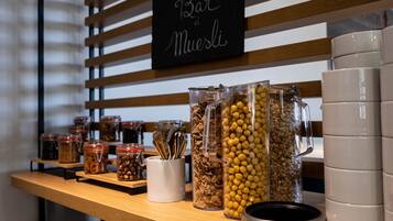 A buffet area with various food containers and utensils.
