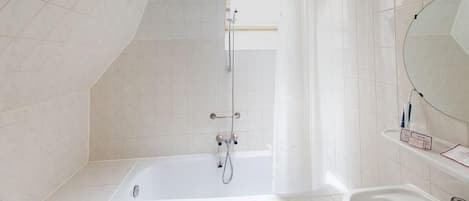 A modern bathroom with a bathtub, a shower, and a sink.