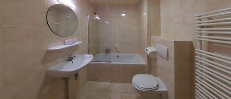 A modern bathroom with a sink, toilet, and bathtub.