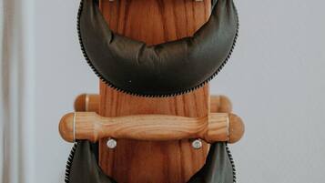 A wooden rack with multiple leather straps.