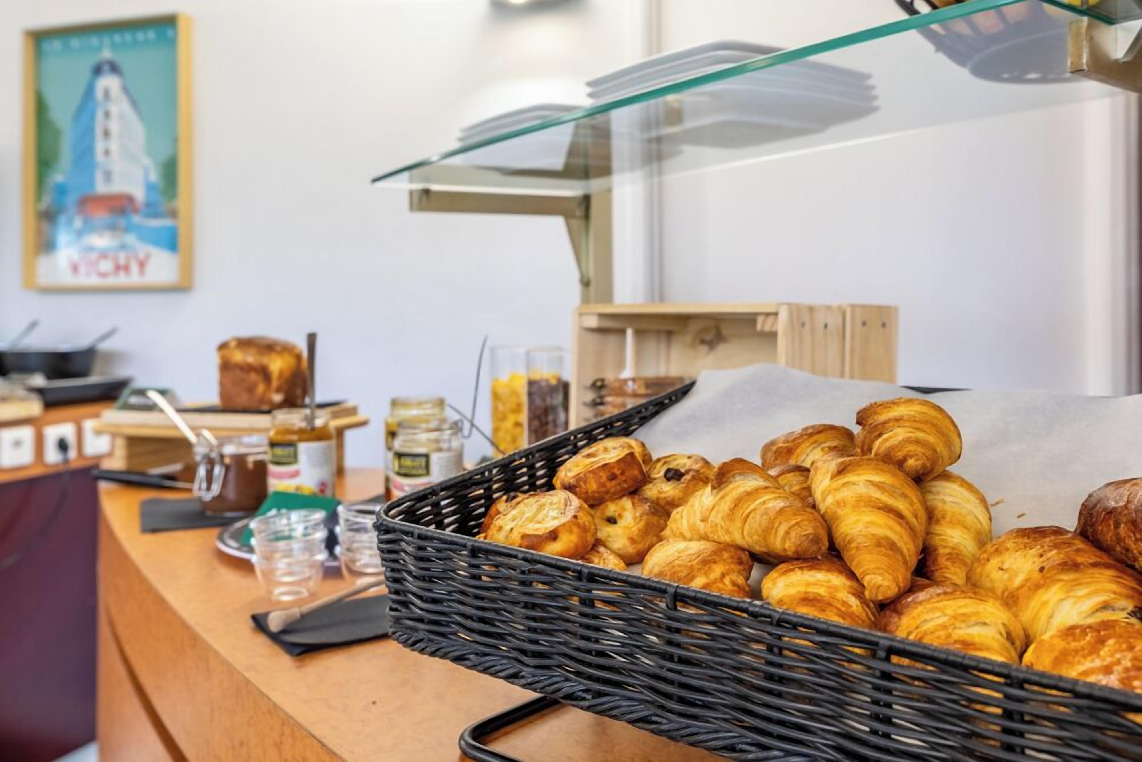 A bakery display with croissants and other baked goods.