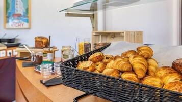 A bakery display with croissants and other baked goods.