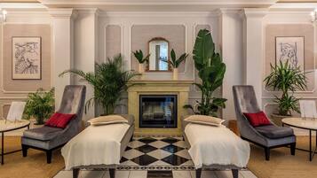 Relax in the elegant lobby, featuring a fireplace, TV, and comfortable seating area.