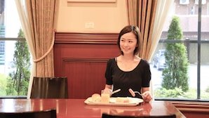 A dining area with a table, chairs, a tray with food and drink, and a window with curtains. - Quintessa Hotel Sasebo (Sasebo)