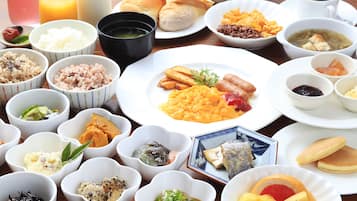 A table with various dishes including rice, soup, and meat.