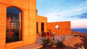 A modern building with large windows and a patio area. - Sky House Kangaroo Island (Middle River)