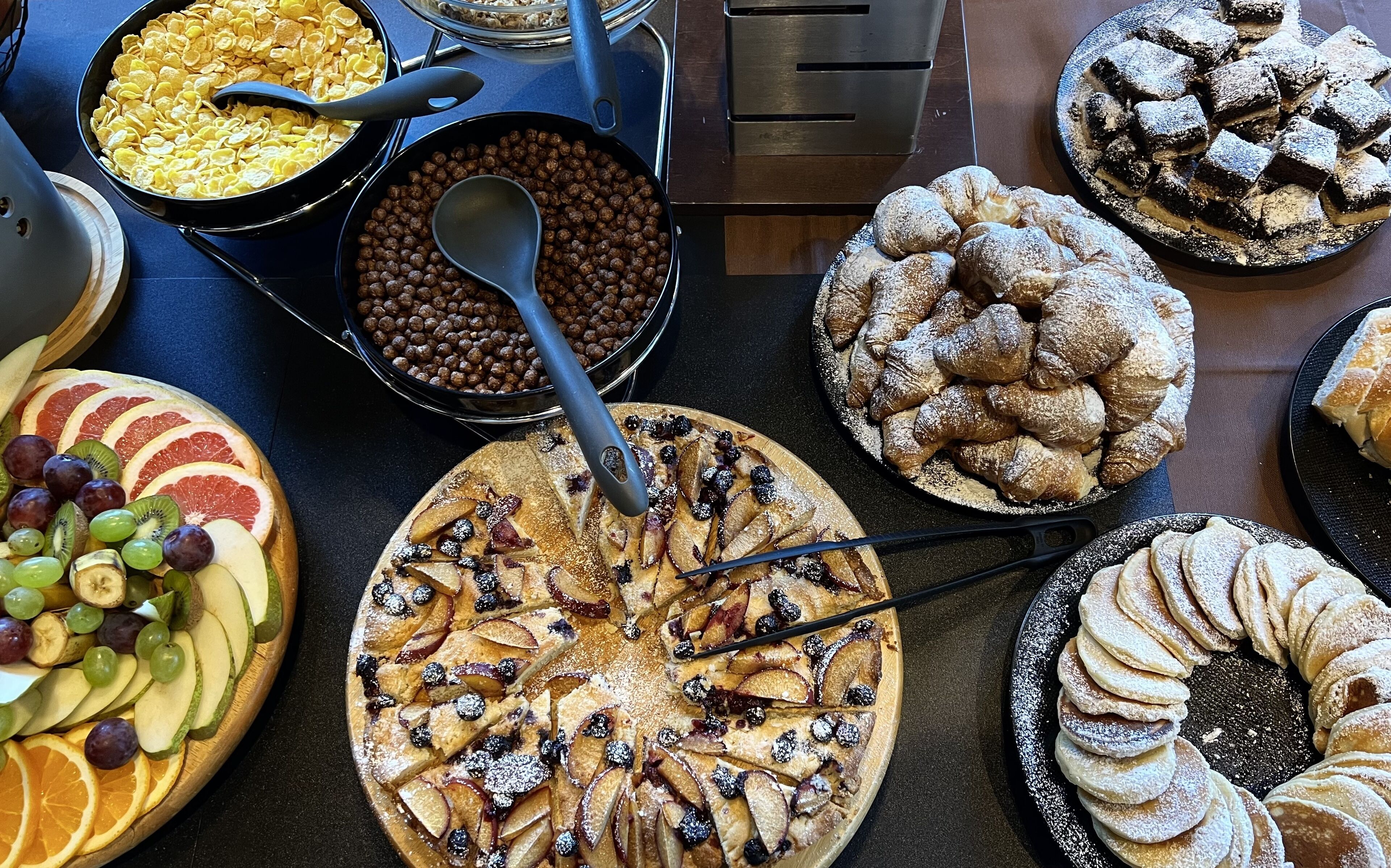 A variety of desserts and fruits on a table.