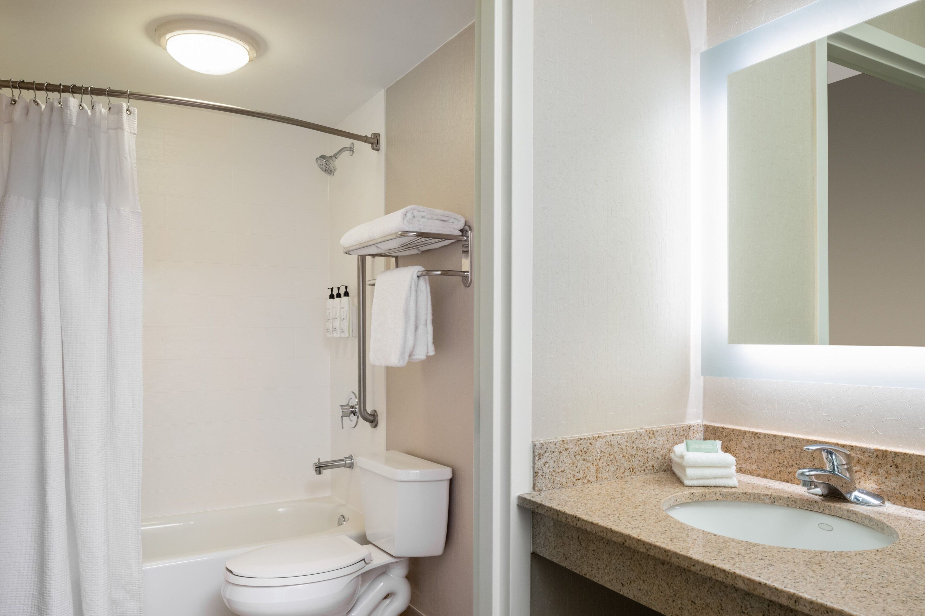 A bathroom with a shower, toilet, and sink.