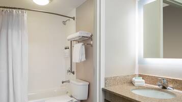 A bathroom with a shower, toilet, and sink.
