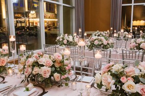 A banquet hall with tables set for a formal event, featuring floral centerpieces and candle lighting. - The Heldrich Hotel (New Brunswick)