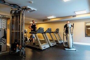 A gym with treadmills, a weight machine, and a stationary bike. - The Heldrich Hotel (New Brunswick)