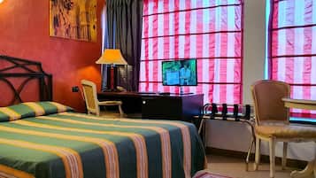 A hotel room with a bed, desk, chair, TV, and a painting on the wall.