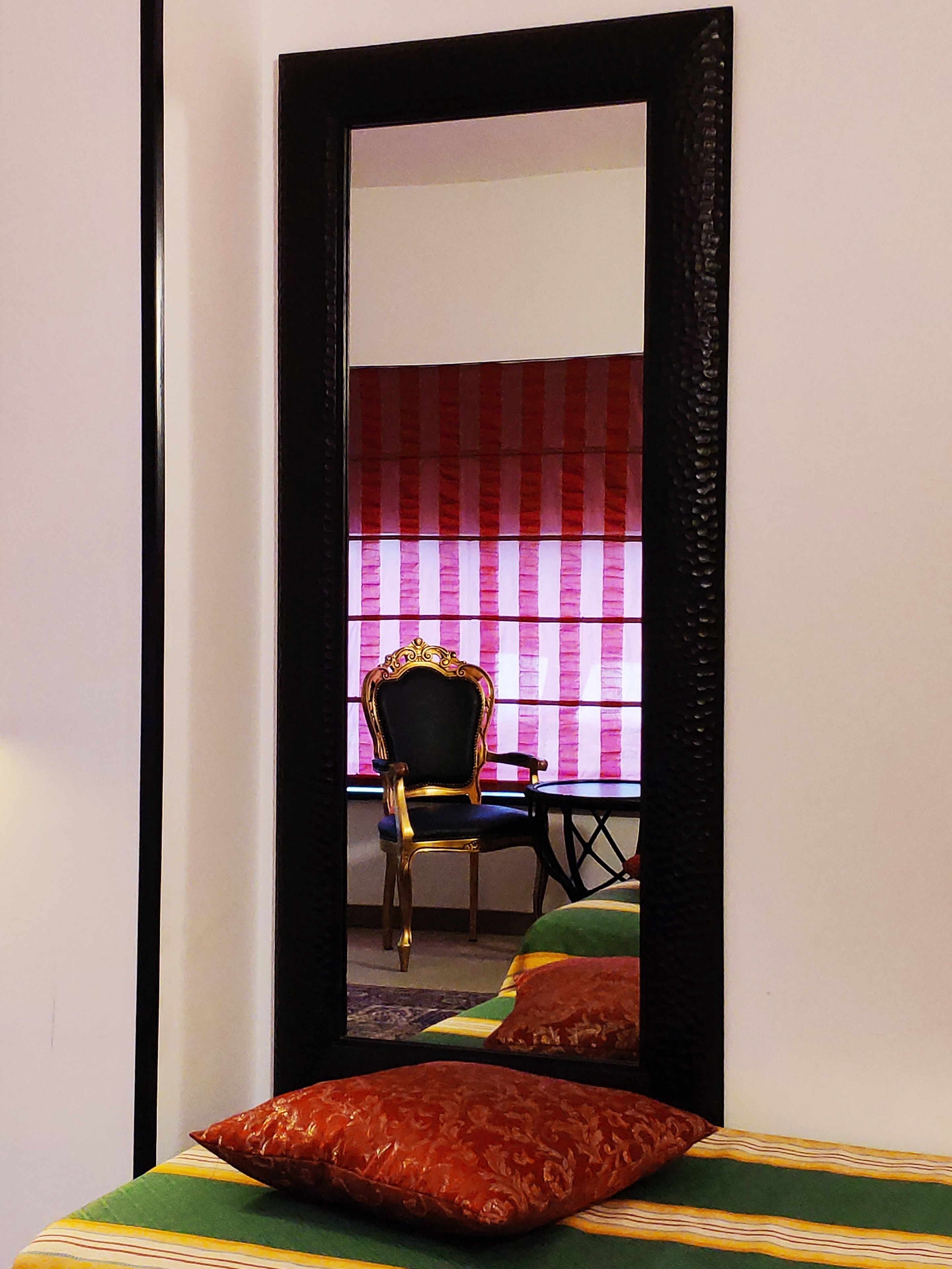 A room with a bed, a chair, and a table.