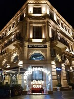 Het uiterlijk van het Austin Hotel met een bord voor de Sicilia Club.