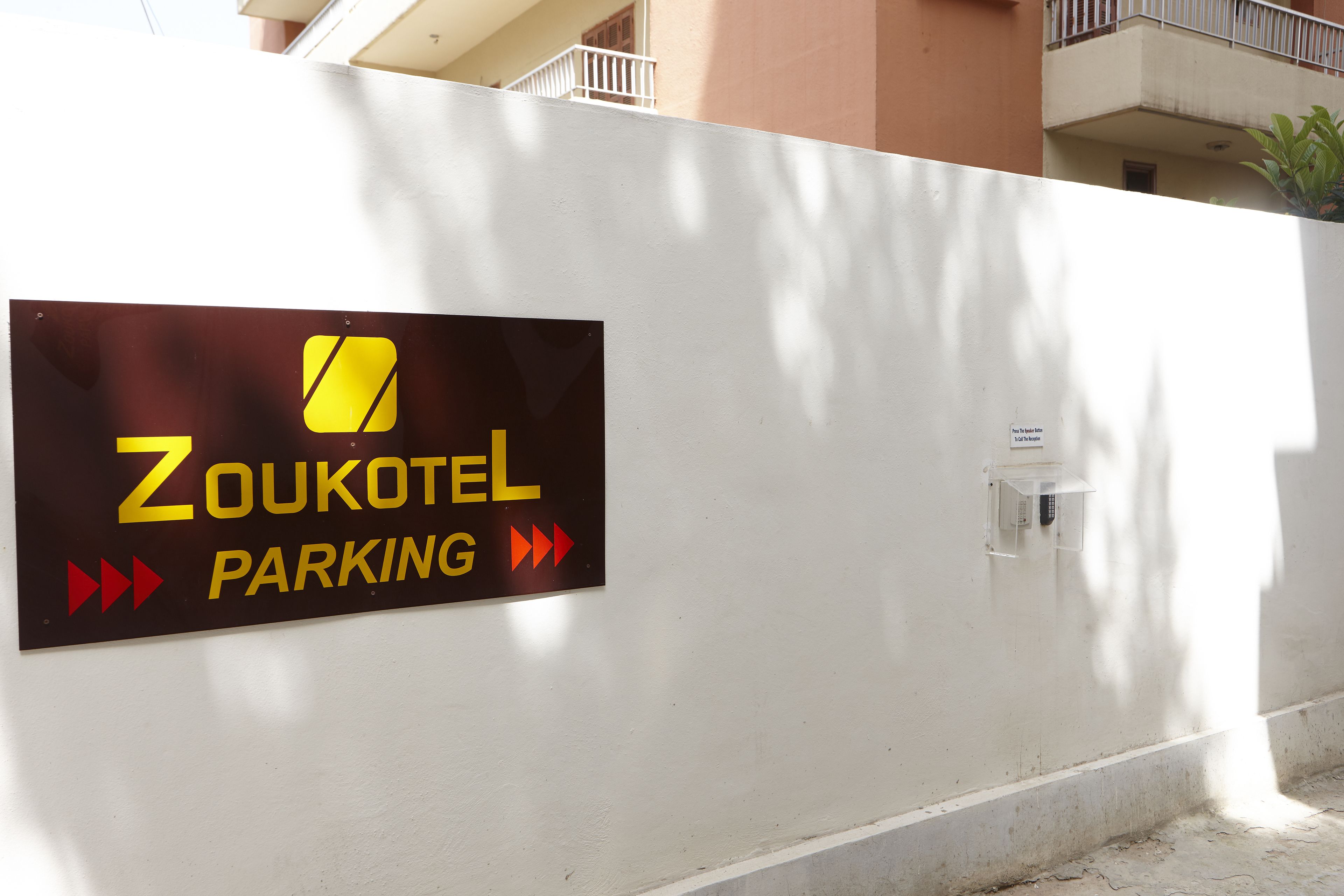 A sign for Zoukotel parking with directional arrows.