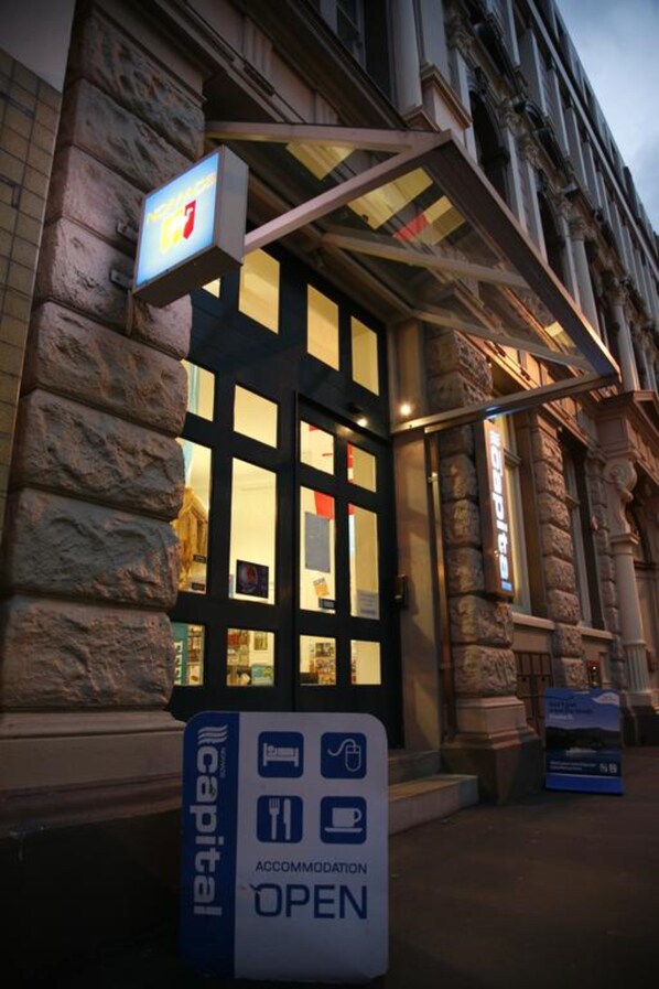 A hotel entrance with a sign indicating 'ACCOMMODATION OPEN'.