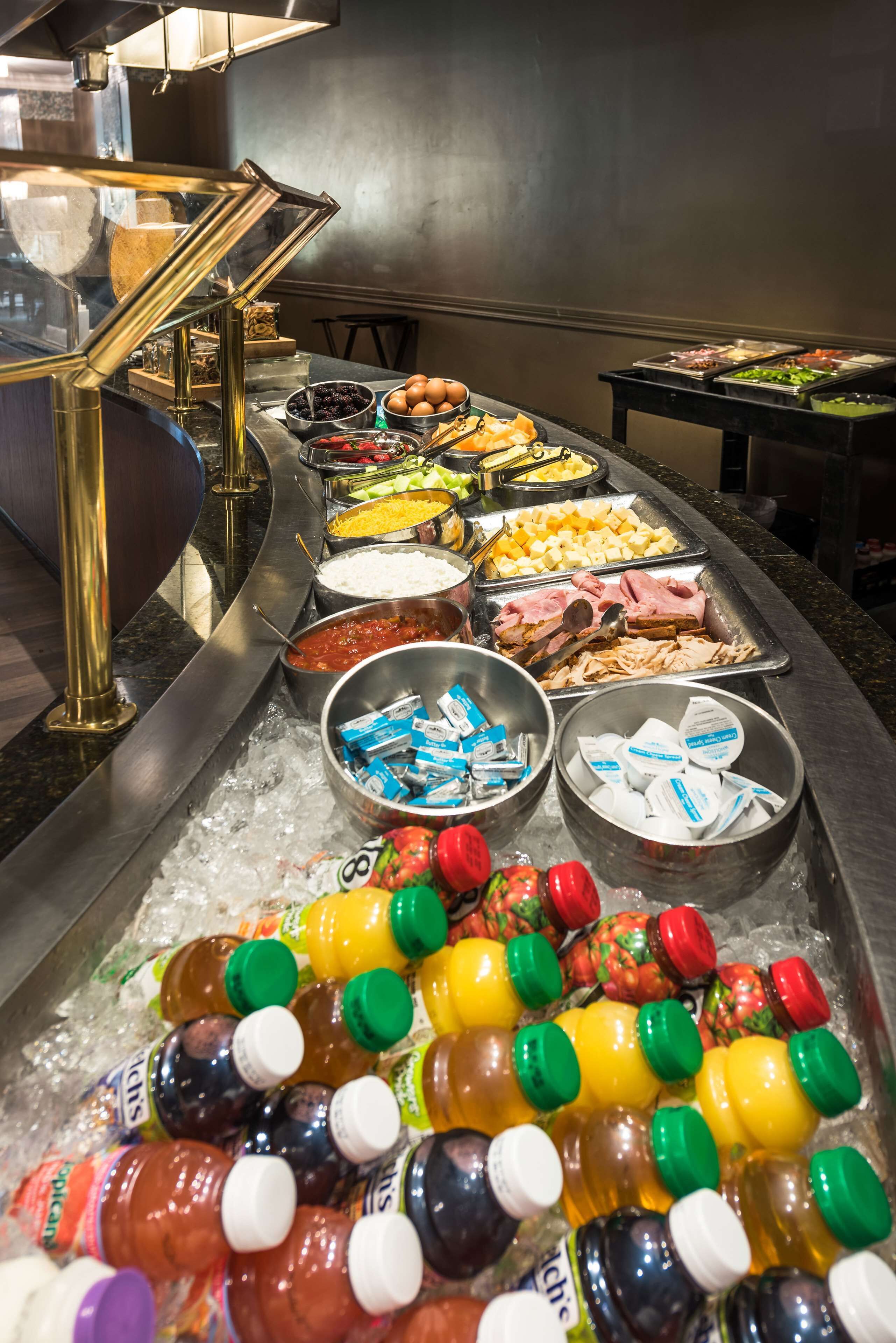A buffet with various food items and beverages.