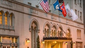 A grand hotel facade with arched windows and a welcoming entrance. - Hilton Baton Rouge Capitol Center (Baton Rouge)
