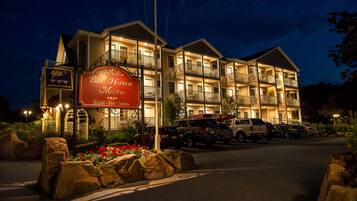 A multi-story hotel with a prominent sign for 'Bar Harbor Manor Hotel - Suites'.