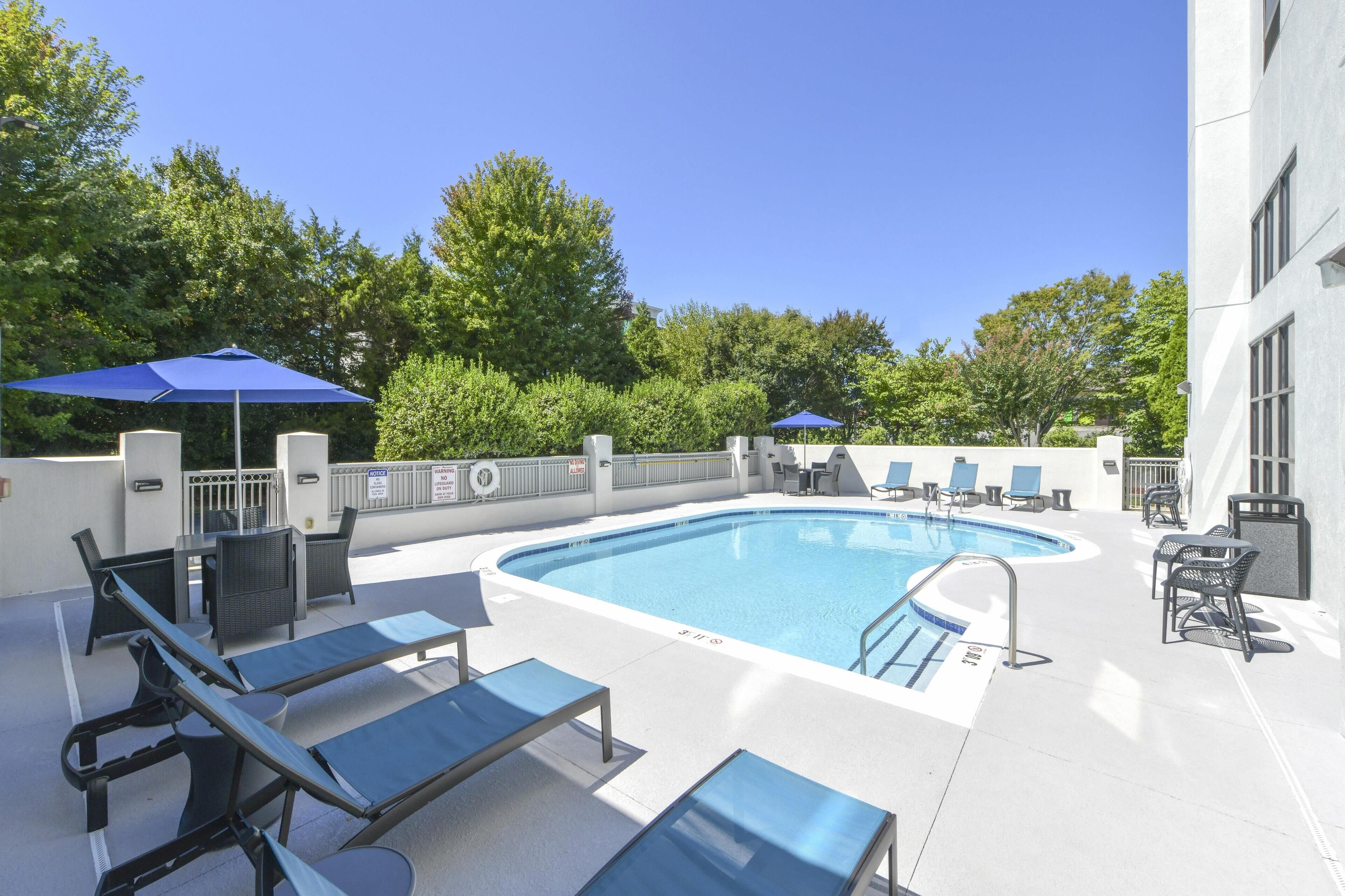Seasonal outdoor pool, open 10:00 AM to 10:00 PM, pool umbrellas